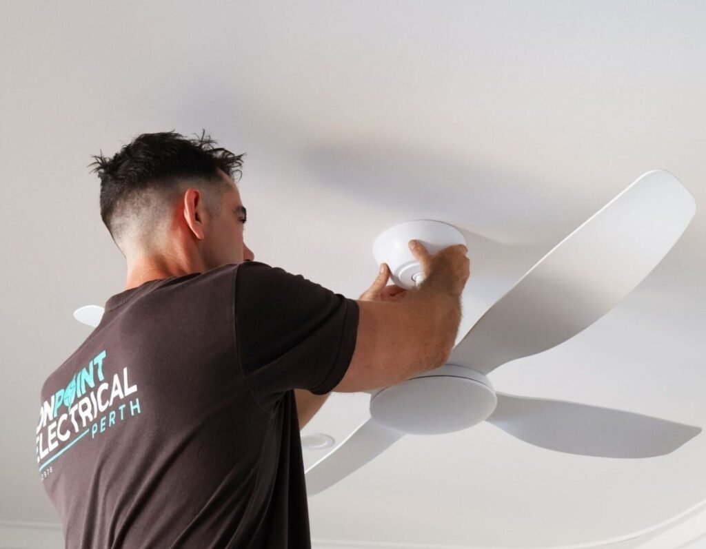 Licensed electrician installing a modern ceiling fan in a residential home in Osborne Park, Perth, providing professional ceiling fan installation and electrical services.