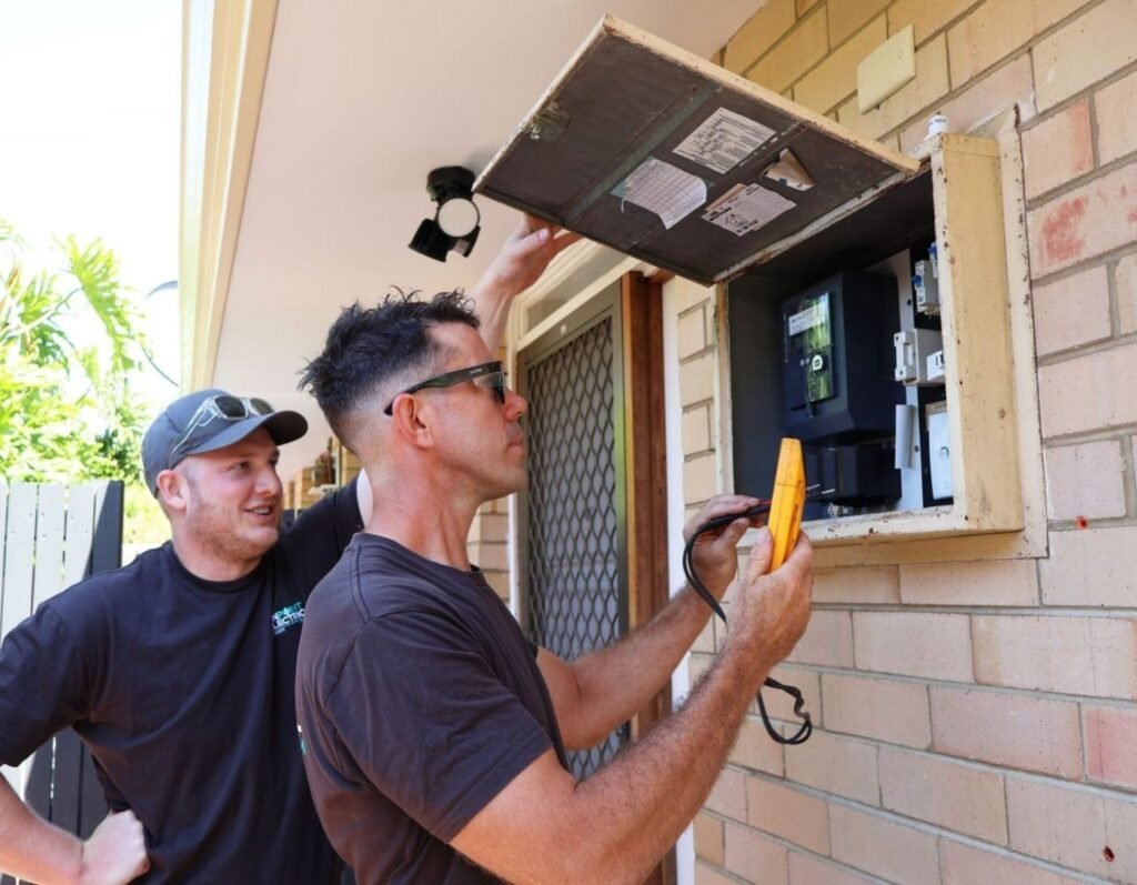 Licensed electricians inspecting and upgrading a residential switchboard at a home in Karrinyup, Perth, providing switchboard upgrades, electrical testing, and safety compliance services.