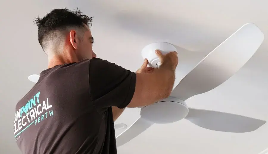 Electrician installing a ceiling fan in a residential property in Woodlands WA.